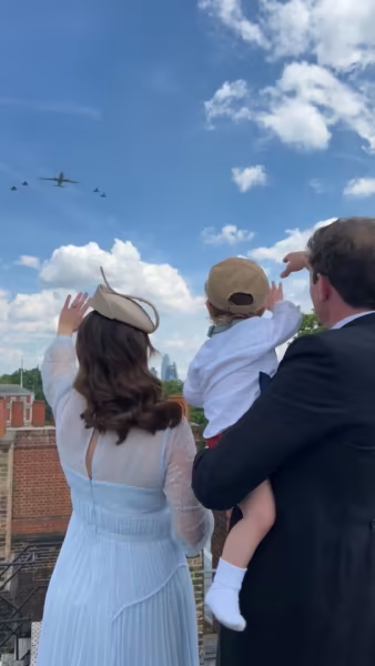 The family of three watched from the roof of St. James Palace