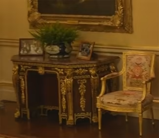 A portrait from Harry and Meghan's wedding is displayed at Buckingham Palace