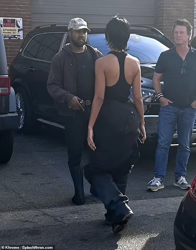 Kanye West packs on the PDA with his 24-year-old girlfriend Juliana Nalu as they share a kiss on set of the model's photoshoot (photos)