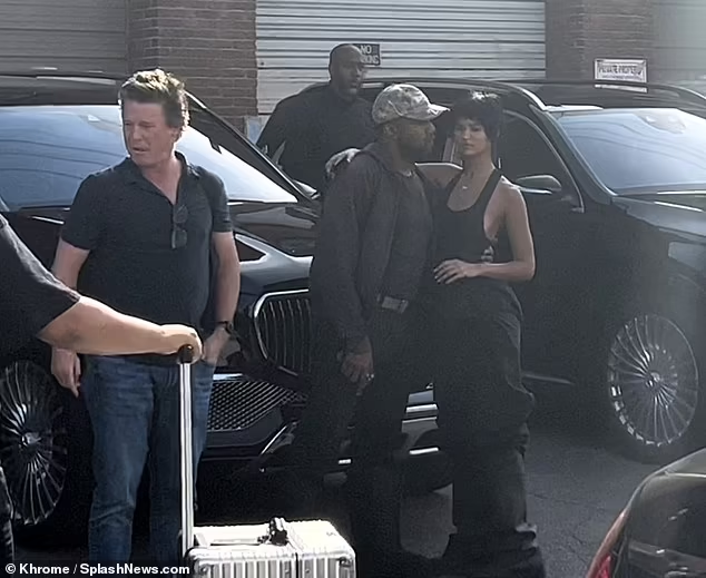 Kanye West packs on the PDA with his 24-year-old girlfriend Juliana Nalu as they share a kiss on set of the model's photoshoot (photos)