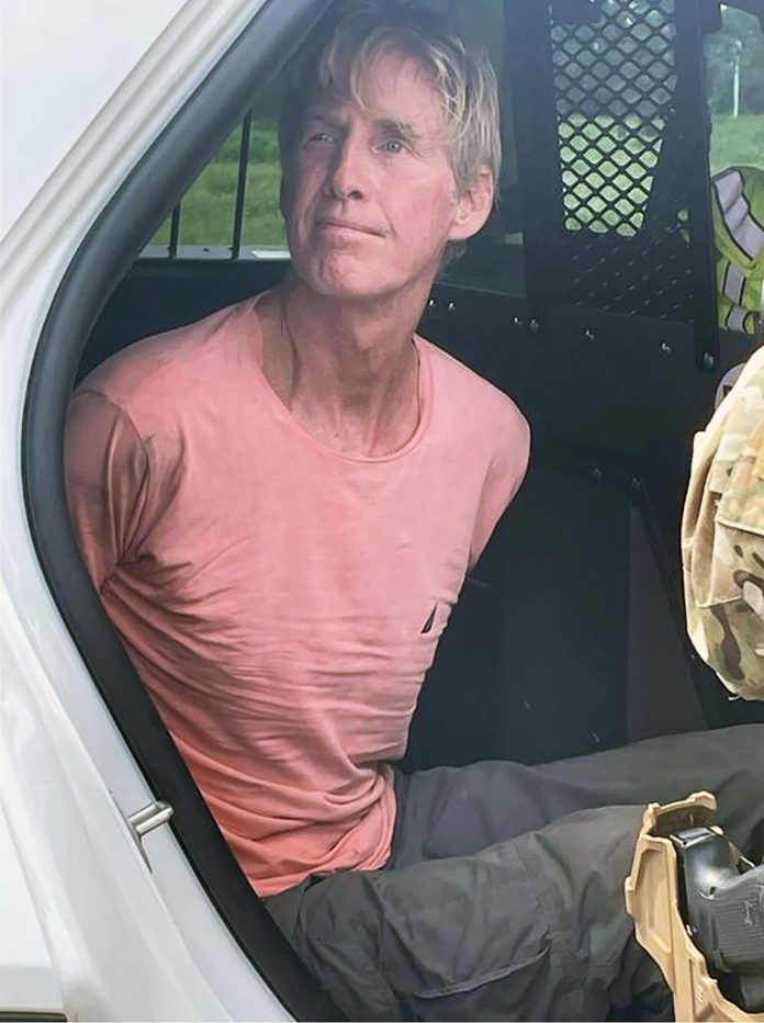 19 Photo of Ryan Wesley Routh after arrest shows him looking calm in back of police car after allegedly attempting to ass@ssinate Trump