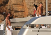 Romeo Beckham STRIPS DOWN with dad David as they show off their tattooed torsos on yacht with Victoria and Kim Turnbull